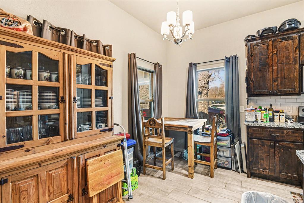 621 North Ave B Springtown, TX 76082 - Photo 17 of 28 a view of a dining room with furniture and chandelier
