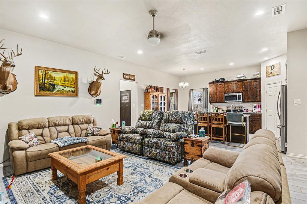 621 North Ave B Springtown, TX 76082 - Photo 18 of 28 a living room with furniture a rug and a flat screen tv
