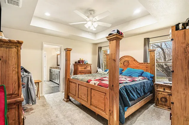 a bedroom with bed and a mirror