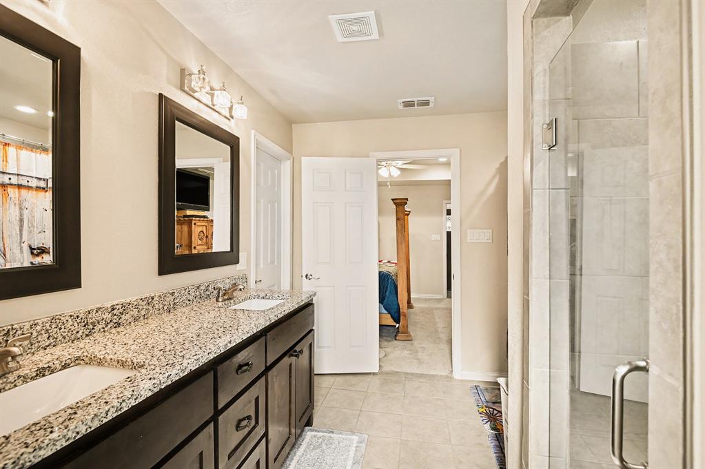 621 North Ave B Springtown, TX 76082 - Photo 22 of 28 a bathroom with a granite countertop sink and a mirror