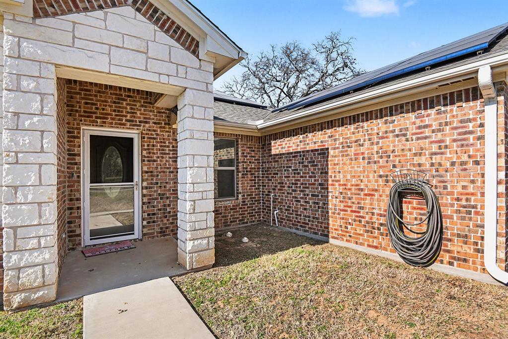 621 North Ave B Springtown, TX 76082 - Photo 4 of 28 a backyard of a house with barbeque oven