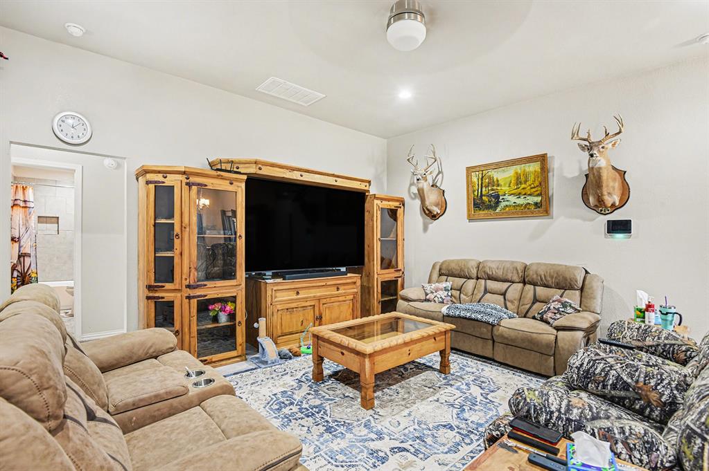 621 North Ave B Springtown, TX 76082 - Photo 5 of 28 a living room with furniture and a flat screen tv
