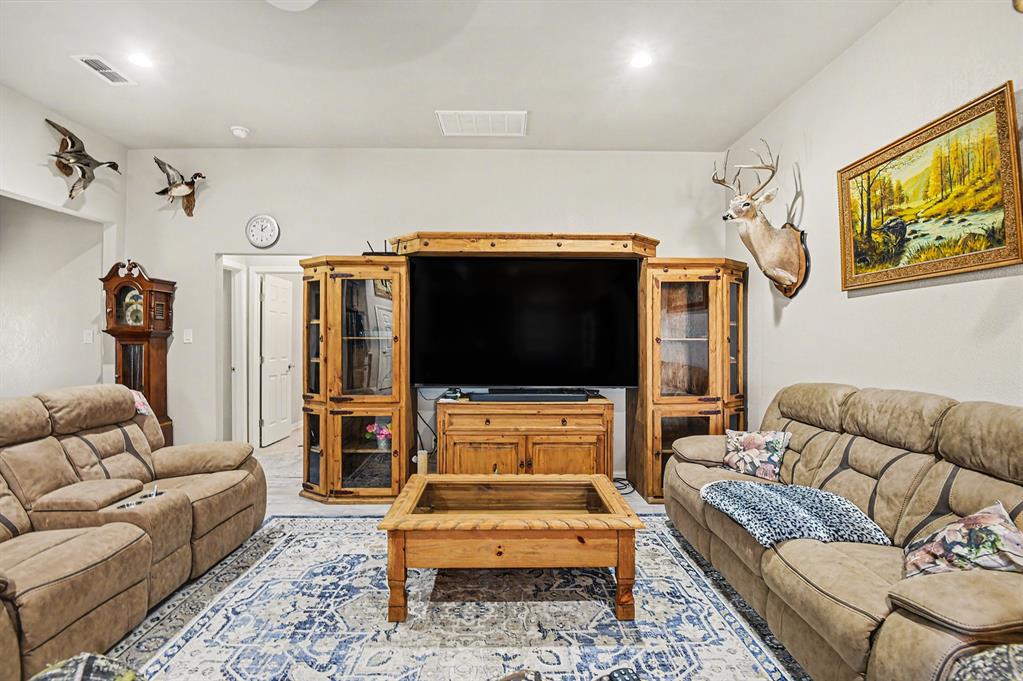 621 North Ave B Springtown, TX 76082 - Photo 6 of 28 a living room with furniture and a flat screen tv