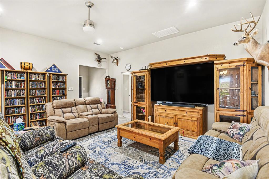 621 North Ave B Springtown, TX 76082 - Photo 9 of 28 a living room with furniture and a flat screen tv