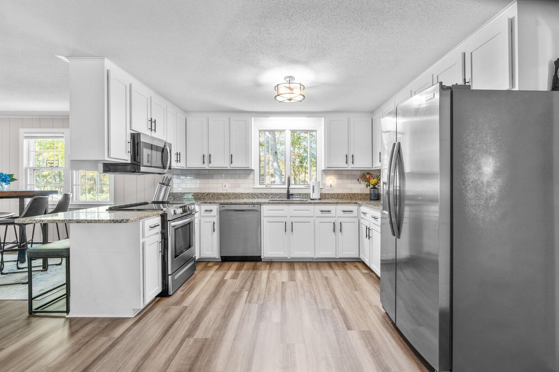 315 Prince Hinckley Road Centerville, MA 02632 - Photo 14 of 39 a kitchen with stainless steel appliances a refrigerator sink and white cabinets