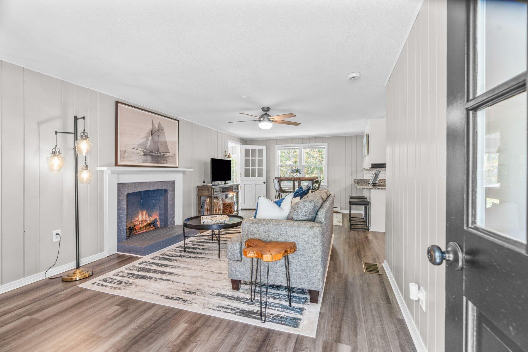 315 Prince Hinckley Road Centerville, MA 02632 - Photo 17 of 39 a living room with furniture a fireplace and a large window