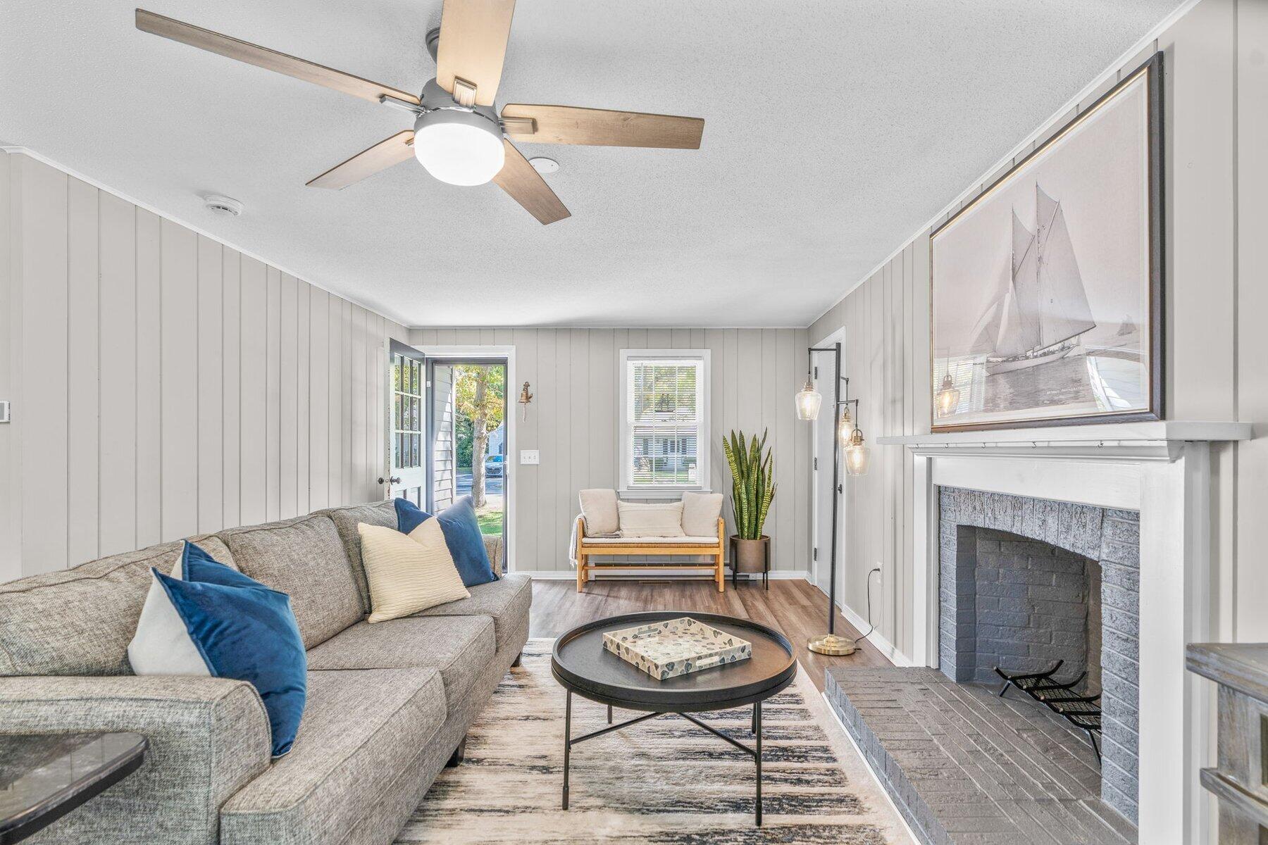 315 Prince Hinckley Road Centerville, MA 02632 - Photo 20 of 39 a living room with furniture a fireplace and a table