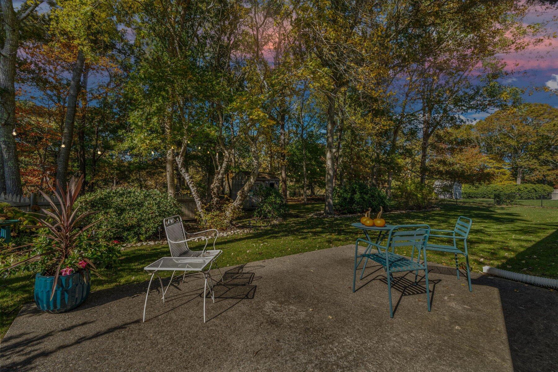 315 Prince Hinckley Road Centerville, MA 02632 - Photo 35 of 39 a garden with a bench and some trees