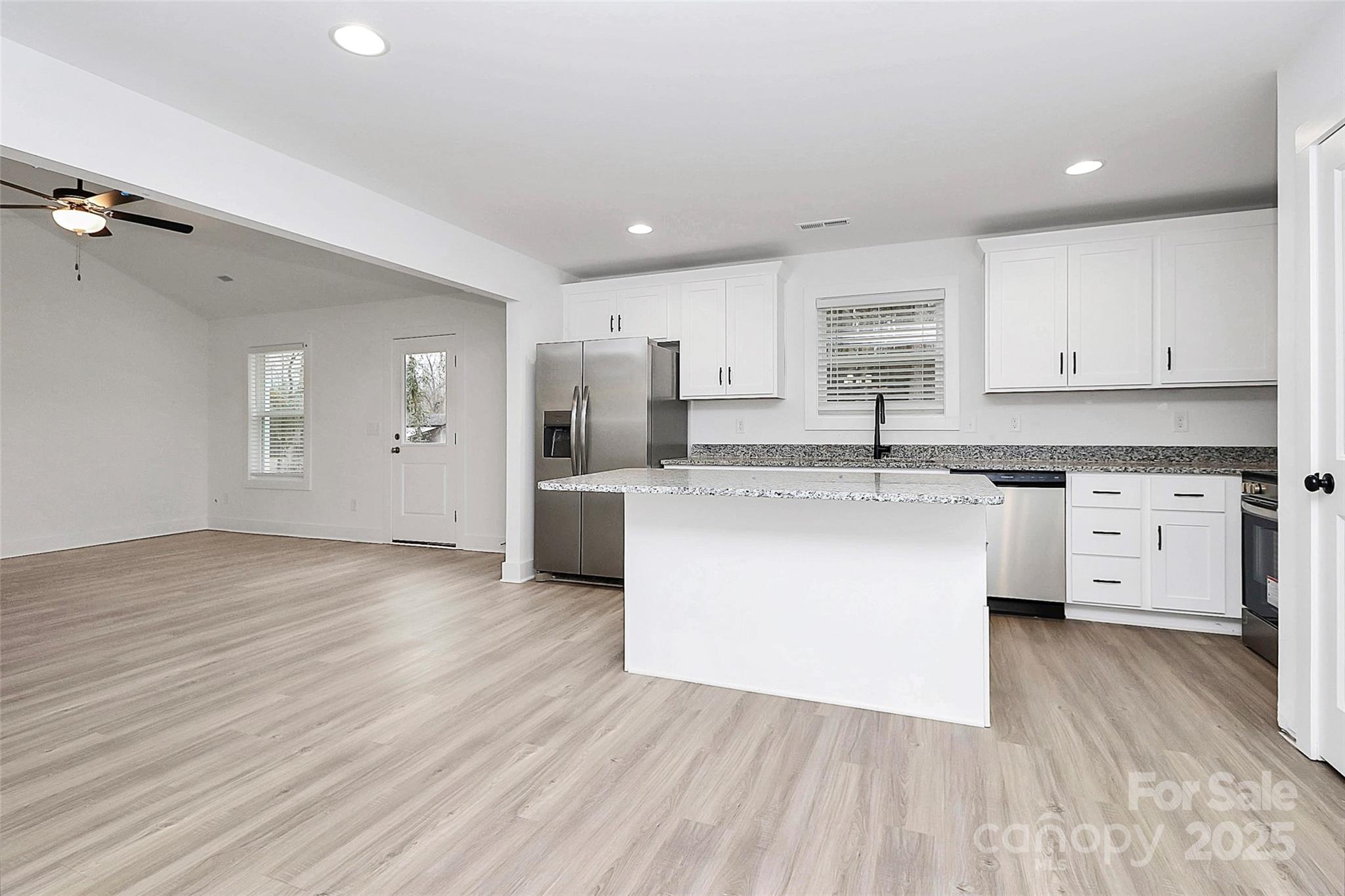 6259 Long Branch Road Salisbury, NC 28147 - Photo 13 of 48 a large kitchen with cabinets wooden floor and stainless steel appliances