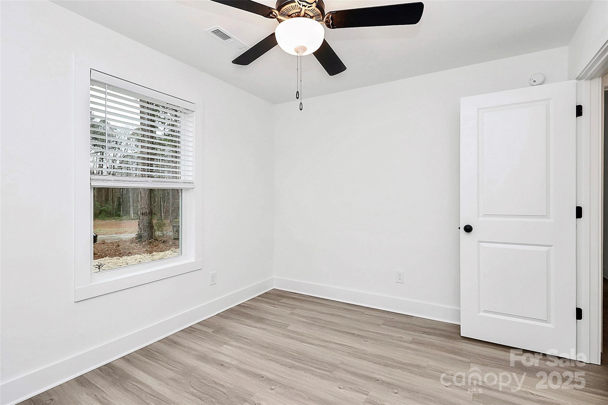6259 Long Branch Road Salisbury, NC 28147 - Photo 29 of 48 a view of an empty room with window and wooden floor