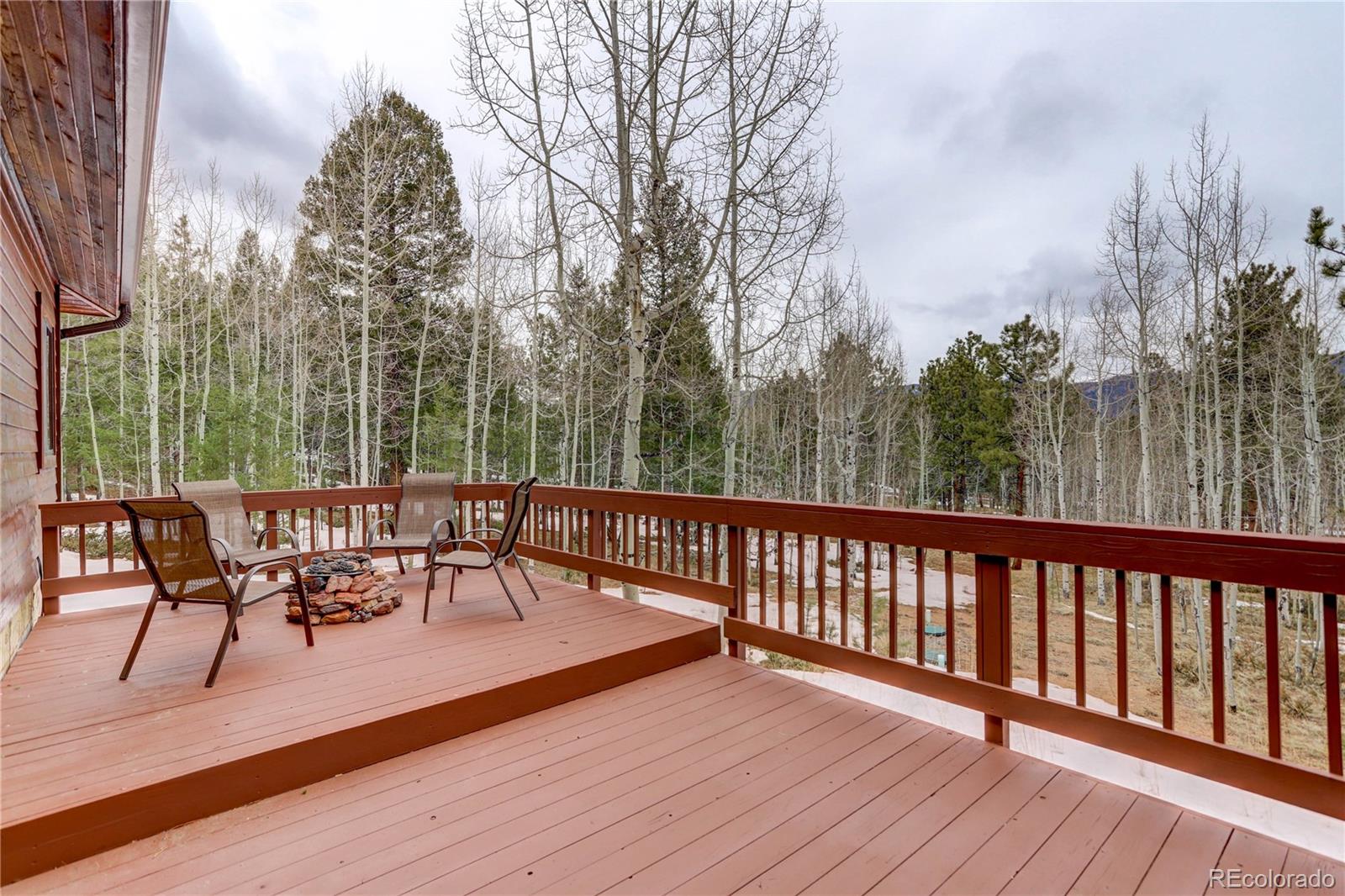 105 Desperado Road Bailey, CO 80421 - Photo 11 of 40 a view of a chairs and table on the wooden floor