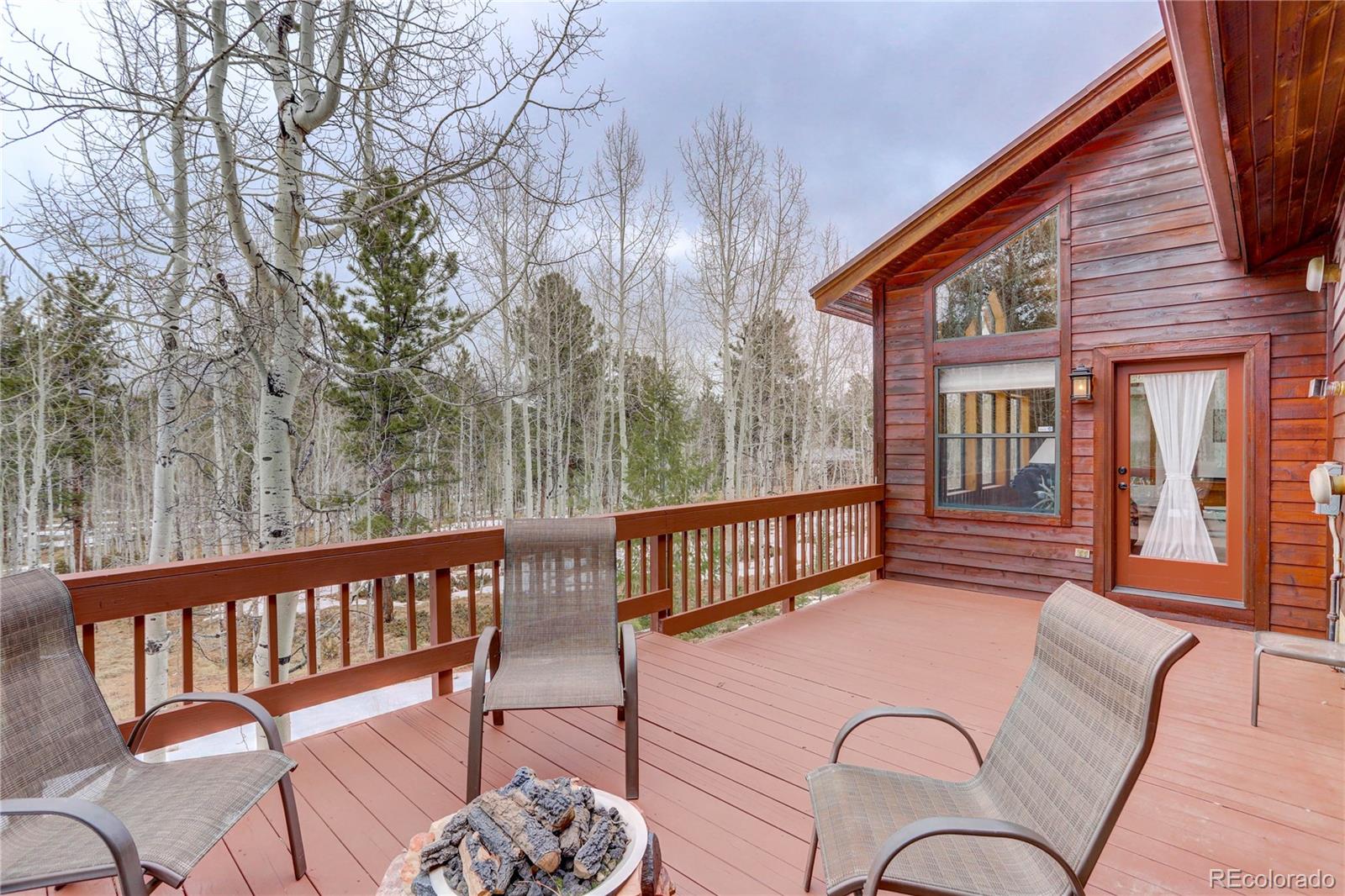 105 Desperado Road Bailey, CO 80421 - Photo 12 of 40 a balcony with hardwood table and chairs