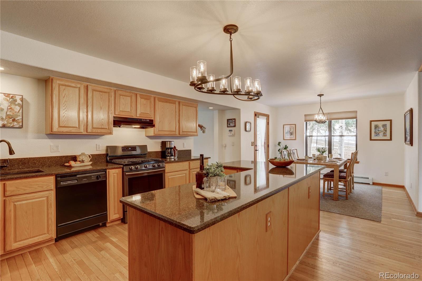 105 Desperado Road Bailey, CO 80421 - Photo 15 of 40 a kitchen with stainless steel appliances granite countertop a sink stove and refrigerator