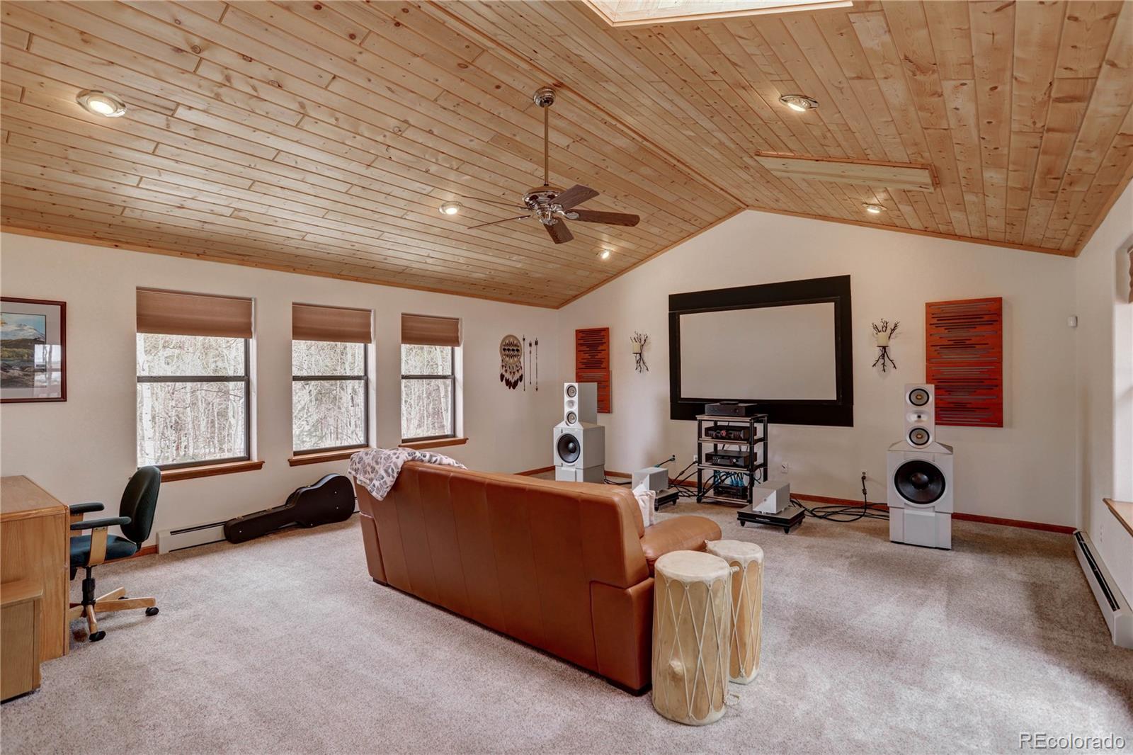 105 Desperado Road Bailey, CO 80421 - Photo 18 of 40 a living room with furniture and a flat screen tv
