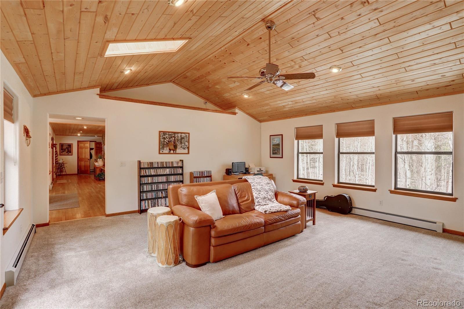 105 Desperado Road Bailey, CO 80421 - Photo 19 of 40 a living room with furniture and a flat screen tv