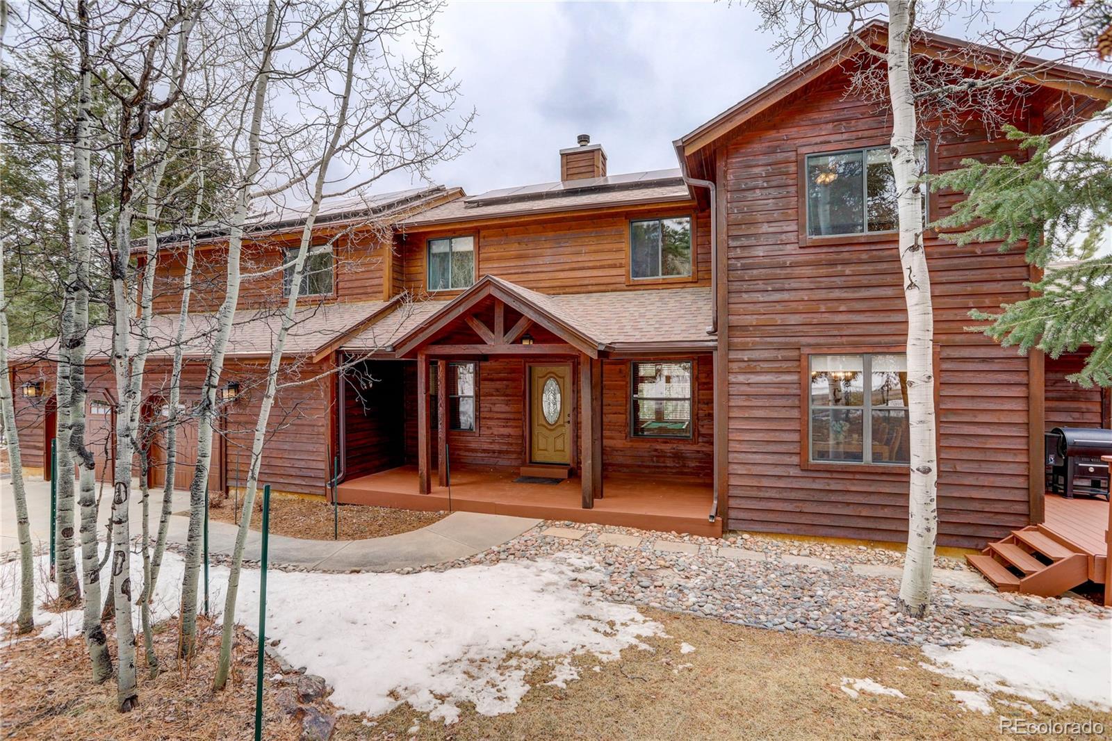 105 Desperado Road Bailey, CO 80421 - Photo 2 of 40 a front view of a house with a yard