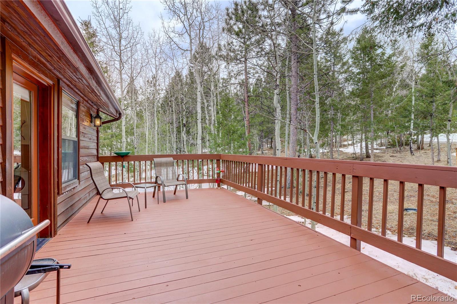 105 Desperado Road Bailey, CO 80421 - Photo 23 of 40 a view of a chairs on deck with wooden floor and fence