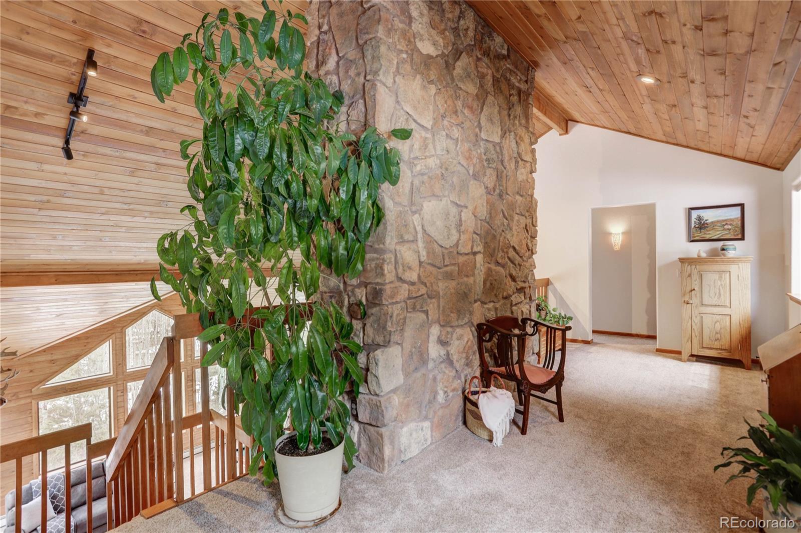 105 Desperado Road Bailey, CO 80421 - Photo 25 of 40 a view of a chairs and table in a patio