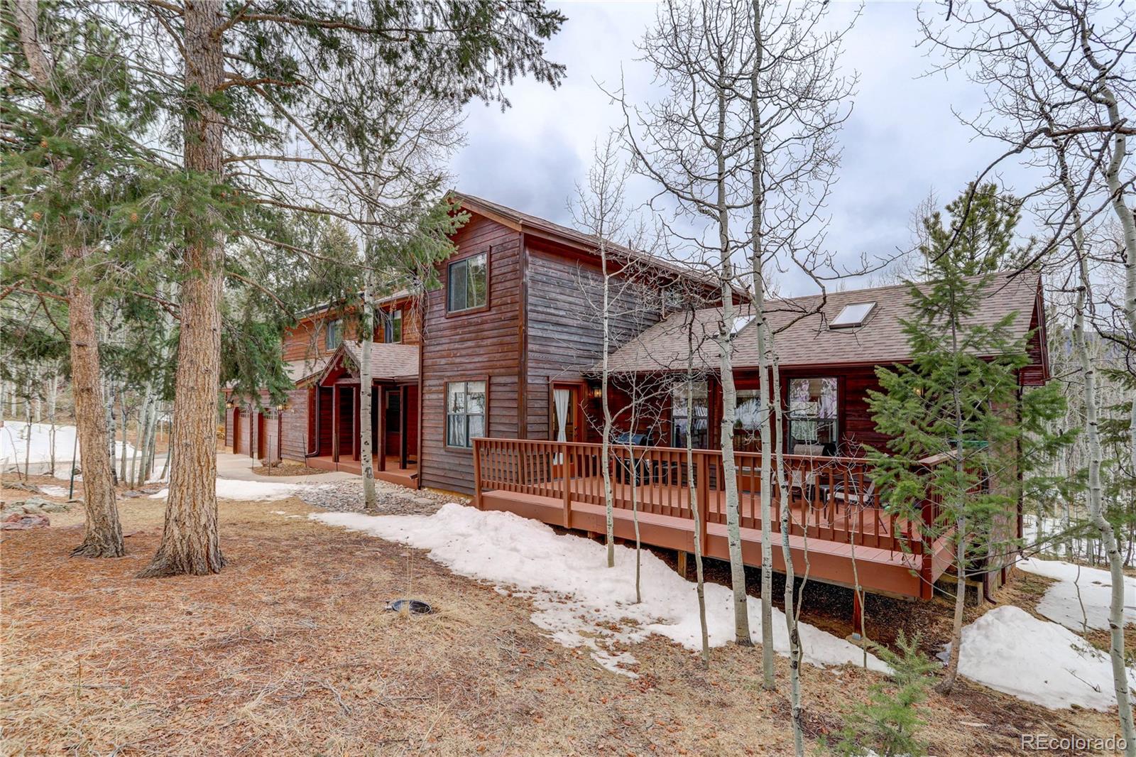 105 Desperado Road Bailey, CO 80421 - Photo 3 of 40 a front view of a house with a yard