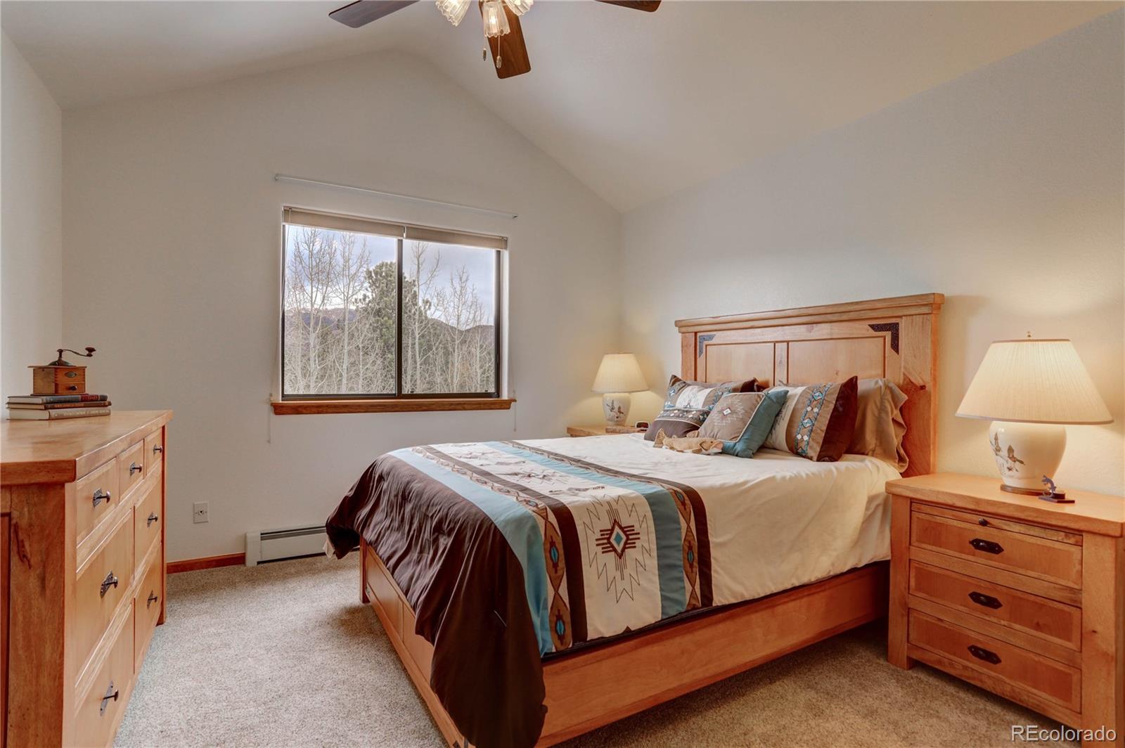 105 Desperado Road Bailey, CO 80421 - Photo 33 of 40 a bedroom with a bed and a dresser next to a window