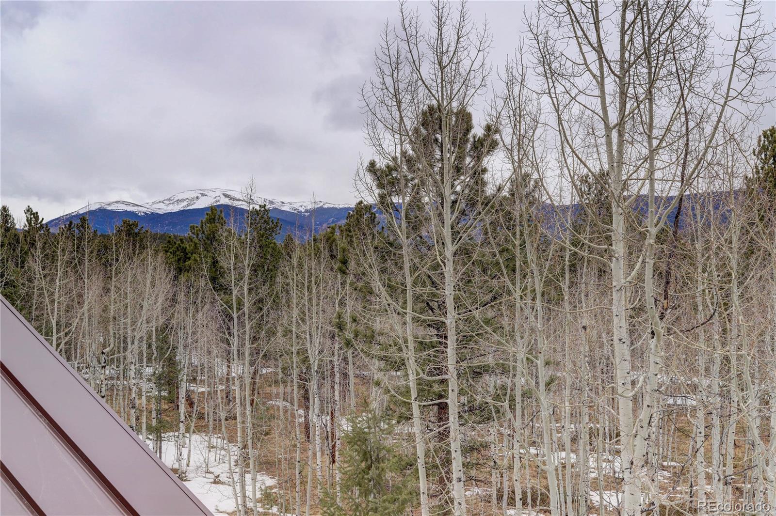105 Desperado Road Bailey, CO 80421 - Photo 34 of 40 a view of a lake with a mountain in the background