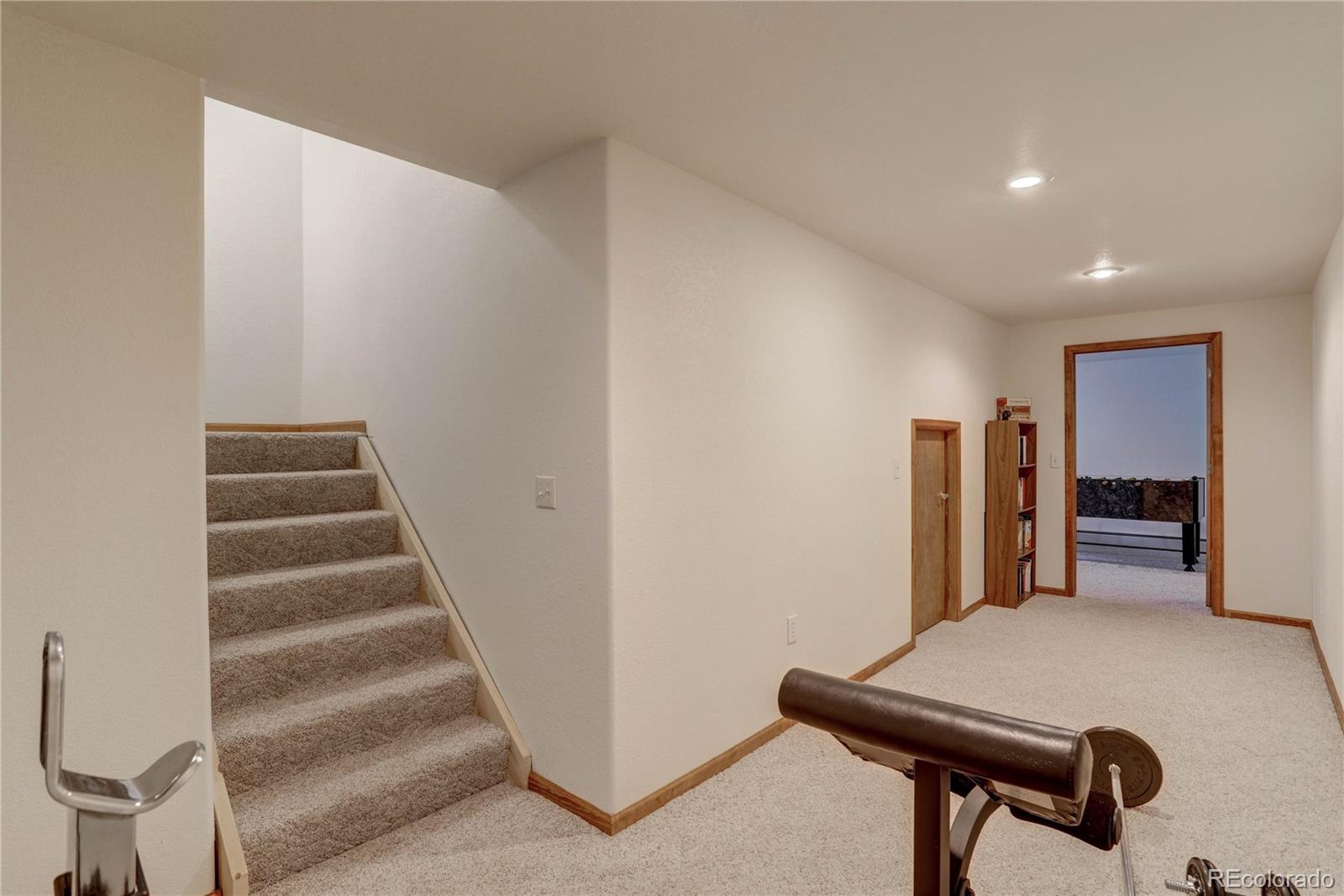 105 Desperado Road Bailey, CO 80421 - Photo 35 of 40 a view of an empty room with stairs