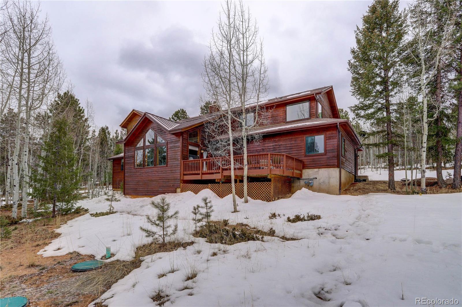 105 Desperado Road Bailey, CO 80421 - Photo 39 of 40 a front view of a house with a yard covered in snow