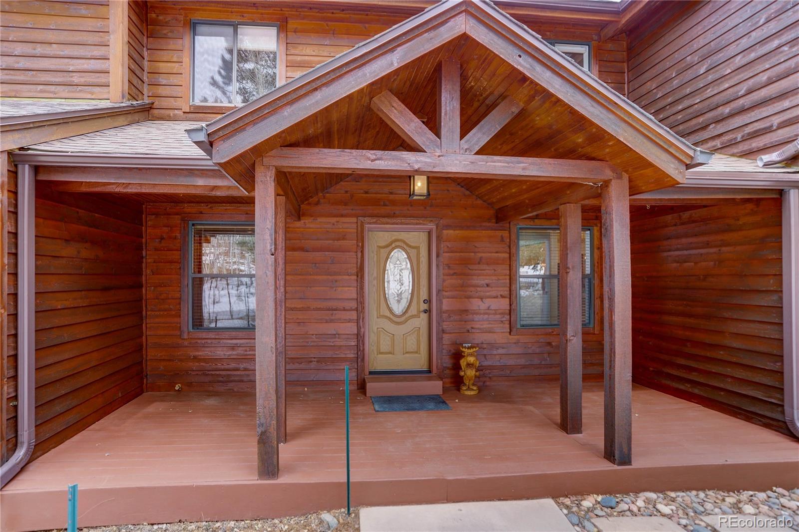 105 Desperado Road Bailey, CO 80421 - Photo 4 of 40 a front view of a house with entryway