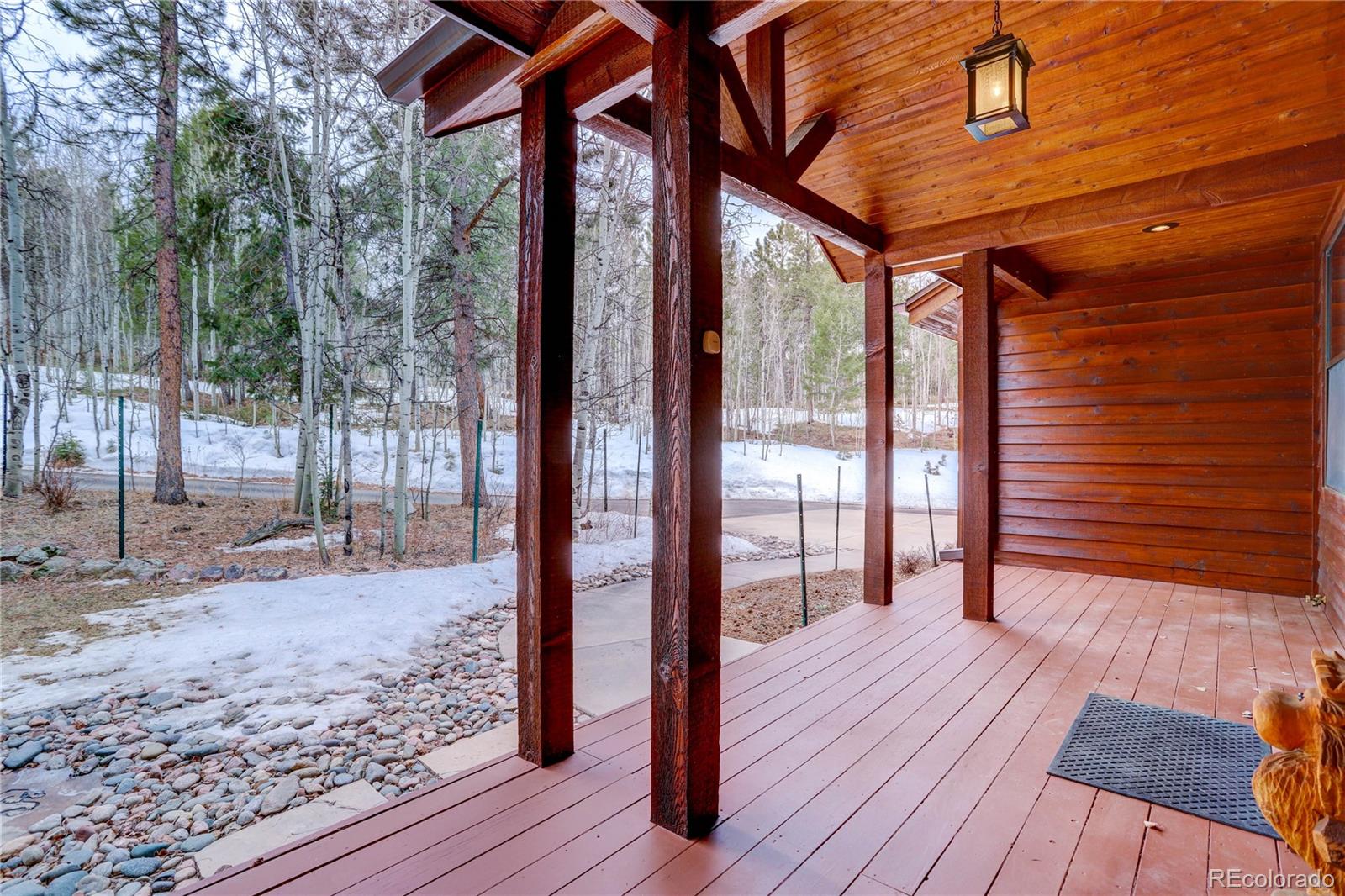 105 Desperado Road Bailey, CO 80421 - Photo 5 of 40 a porch with wooden floor