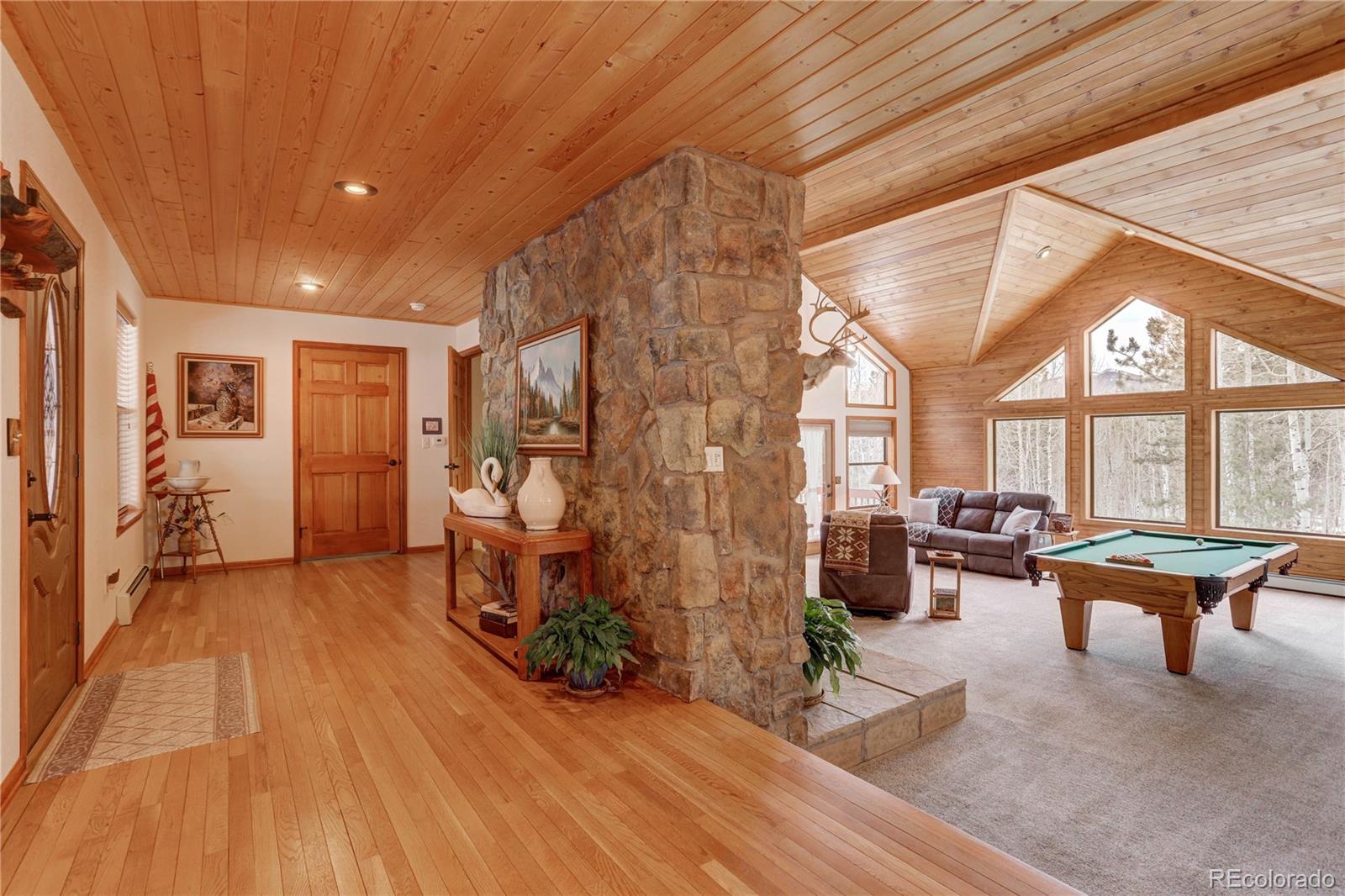 105 Desperado Road Bailey, CO 80421 - Photo 7 of 40 a living room with furniture and wooden floor