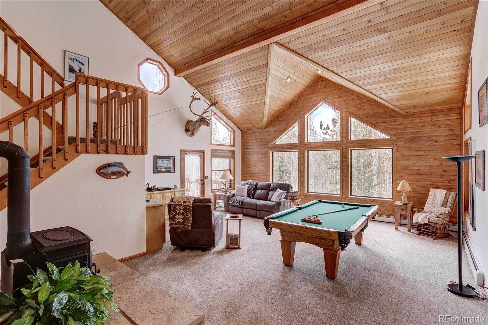 105 Desperado Road Bailey, CO 80421 - Photo 8 of 40 a living room with furniture a rug and a large window