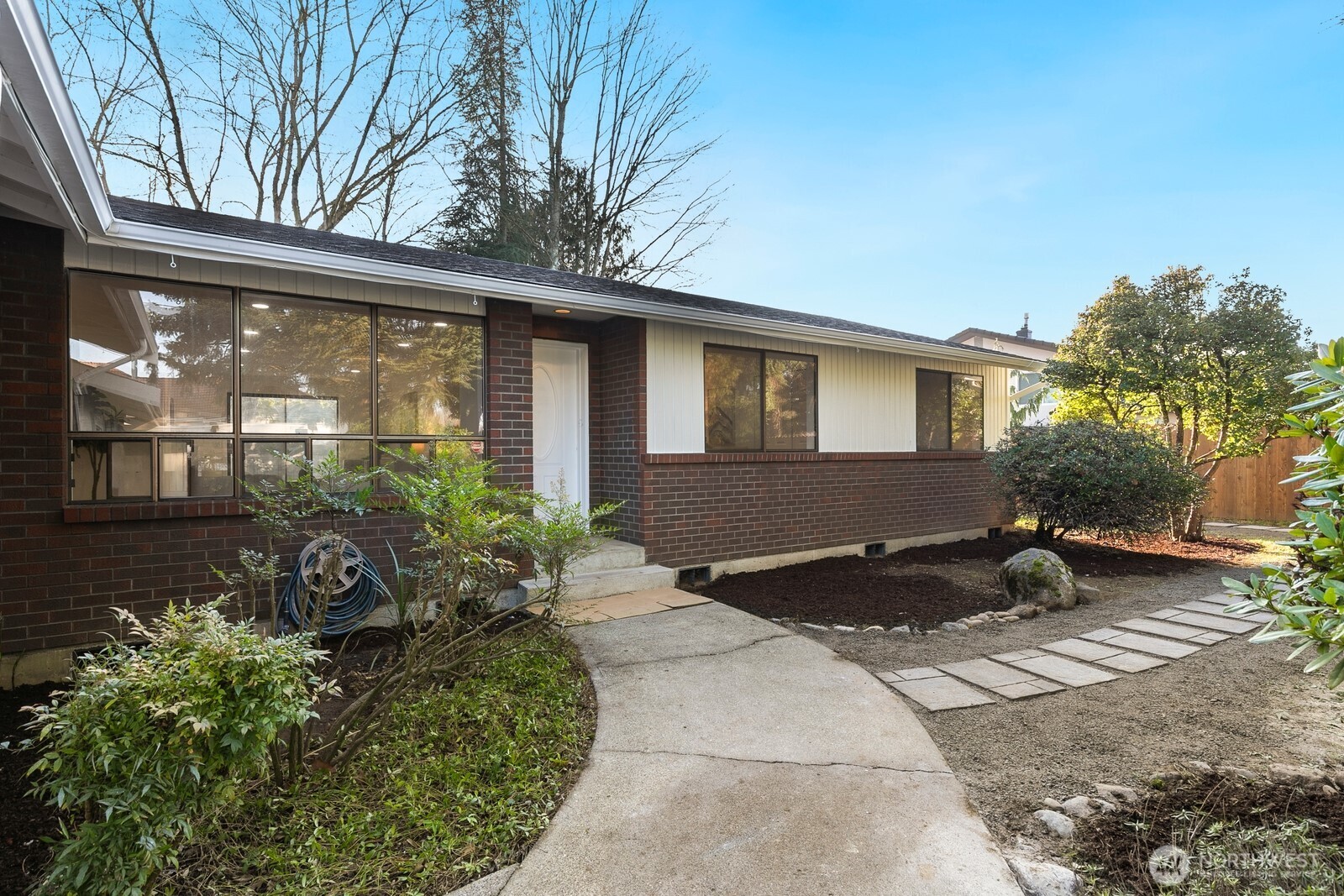 a couple of flower plants in front of house