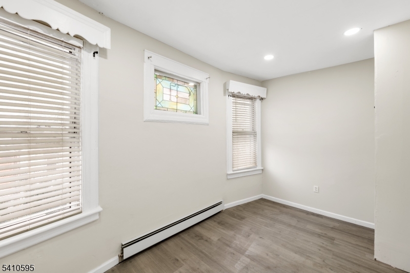 335 Boulevard Passaic, NJ 07055 - Photo 13 of 35 an empty room with wooden floor and windows