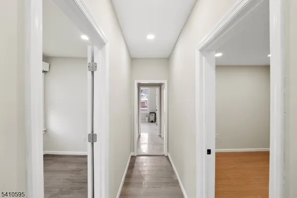 a view of a hallway with wooden floor