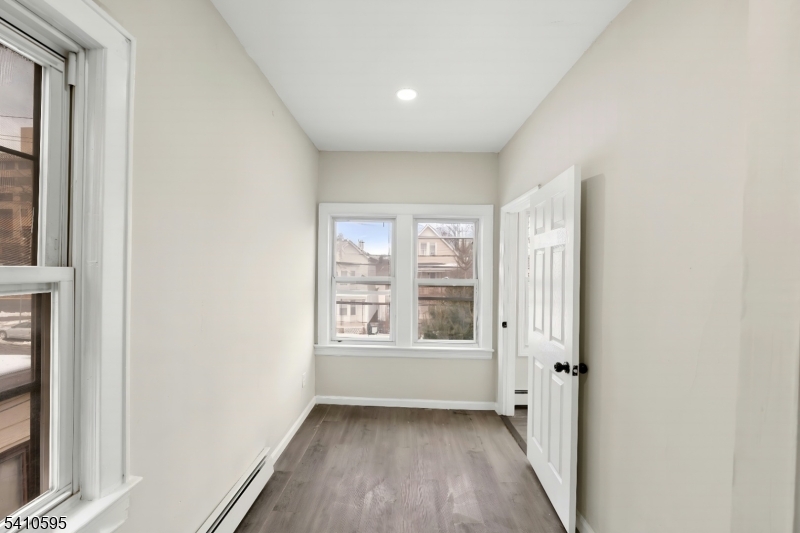 335 Boulevard Passaic, NJ 07055 - Photo 21 of 35 a view of an empty room with wooden floor and a window