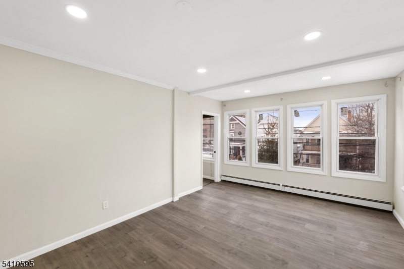 335 Boulevard Passaic, NJ 07055 - Photo 8 of 35 an empty room with wooden floor and windows