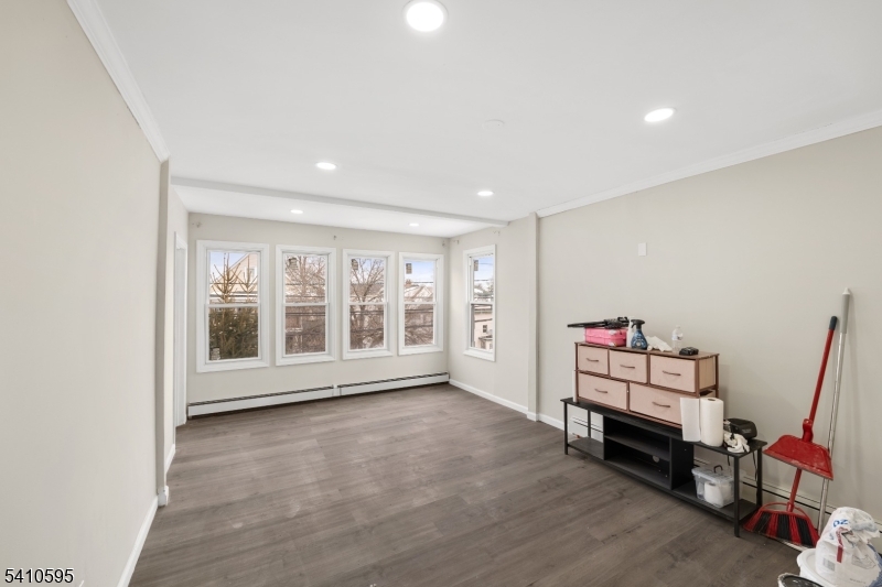 335 Boulevard Passaic, NJ 07055 - Photo 10 of 35 a room with furniture and wooden floor