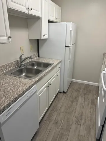 a kitchen with a sink and a refrigerator