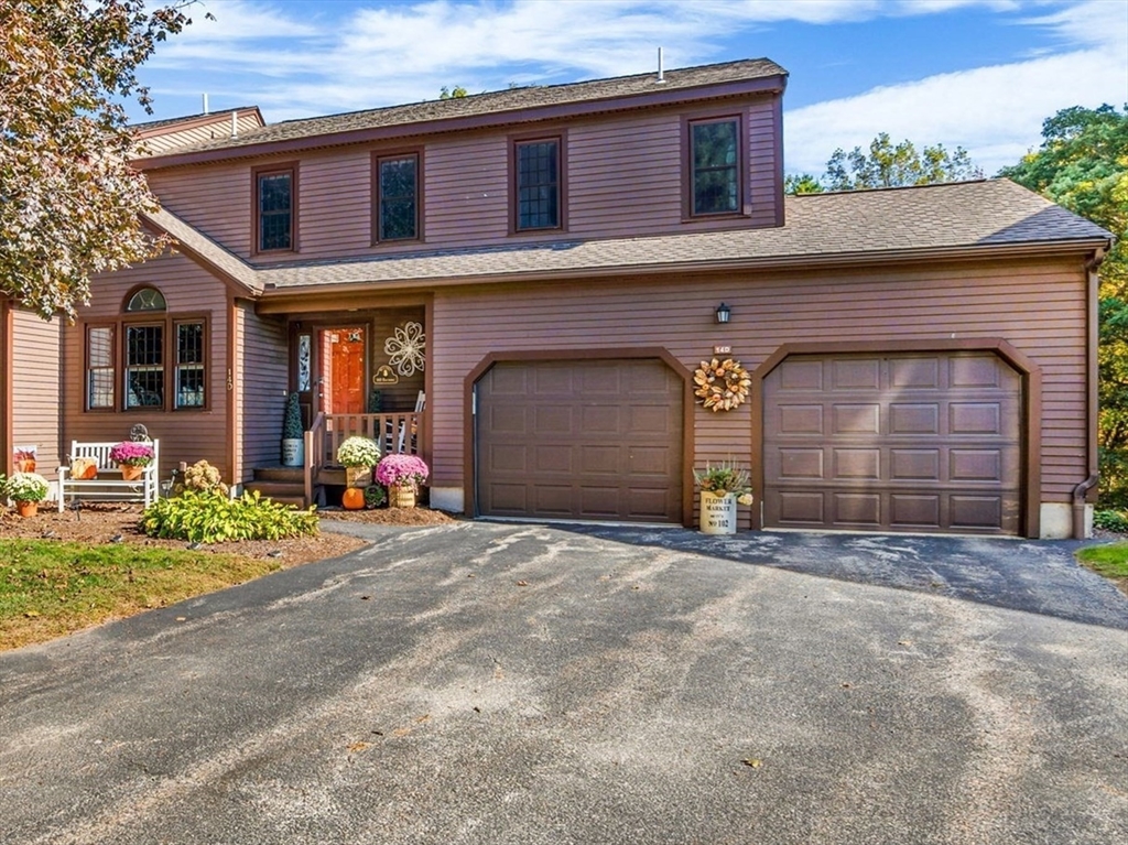 14 Hawthorne Village, Unit D Franklin, MA 02038 - Photo 2 of 42 a front view of a house with a yard and garage