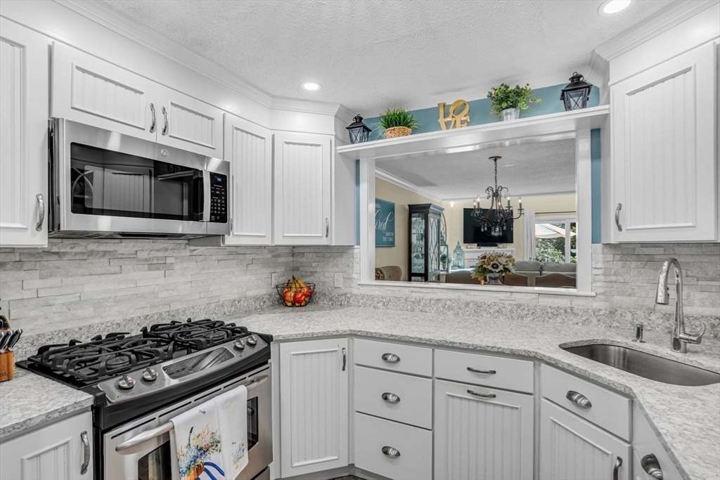 14 Hawthorne Village, Unit D Franklin, MA 02038 - Photo 8 of 42 a kitchen with granite countertop a sink stainless steel appliances and cabinets