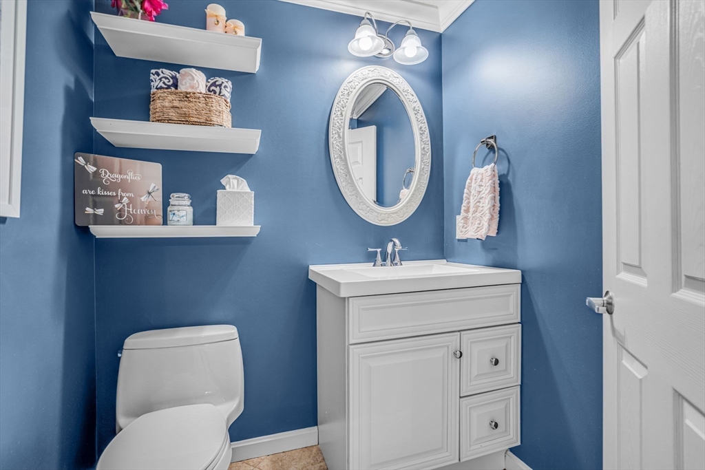 14 Hawthorne Village, Unit D Franklin, MA 02038 - Photo 10 of 42 a bathroom with a toilet sink vanity and mirror