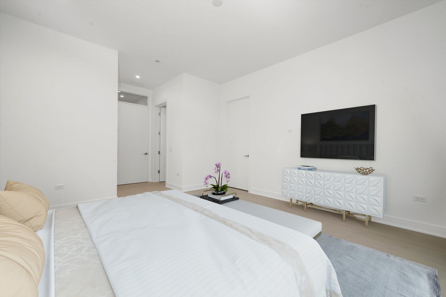 323 South Racine Avenue, Unit 3C Chicago, IL 60607 - Photo 10 of 18 a bedroom with a bed and a flat screen tv