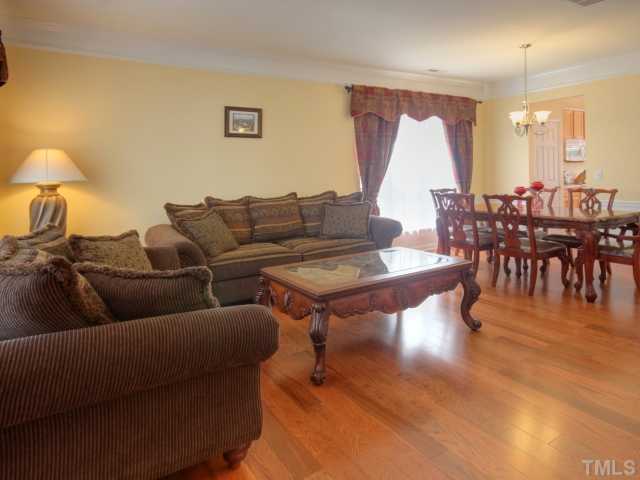 7409 Lagrange Drive Raleigh, NC 27613 - Photo 6 of 25 a living room with furniture and a dining table with wooden floor