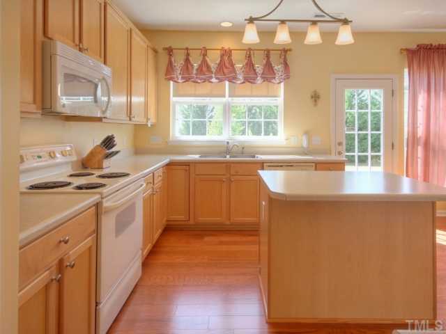 7409 Lagrange Drive Raleigh, NC 27613 - Photo 8 of 25 a kitchen with a sink a counter top space and cabinets