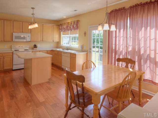 7409 Lagrange Drive Raleigh, NC 27613 - Photo 9 of 25 a kitchen with a dining table chairs and window