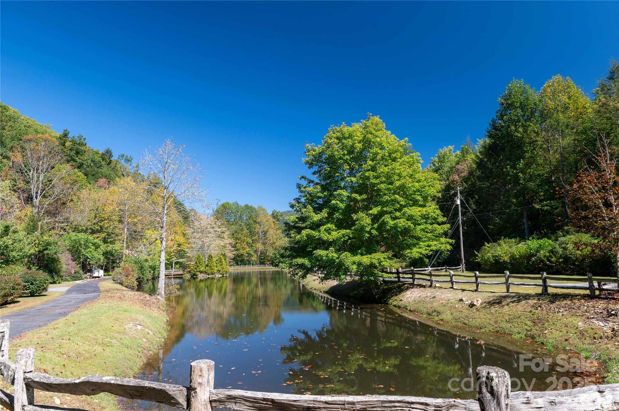 188 Sweetwater Ridge Green Mountain, NC 28740 - Photo 21 of 30 a view of a lake with a house in the background