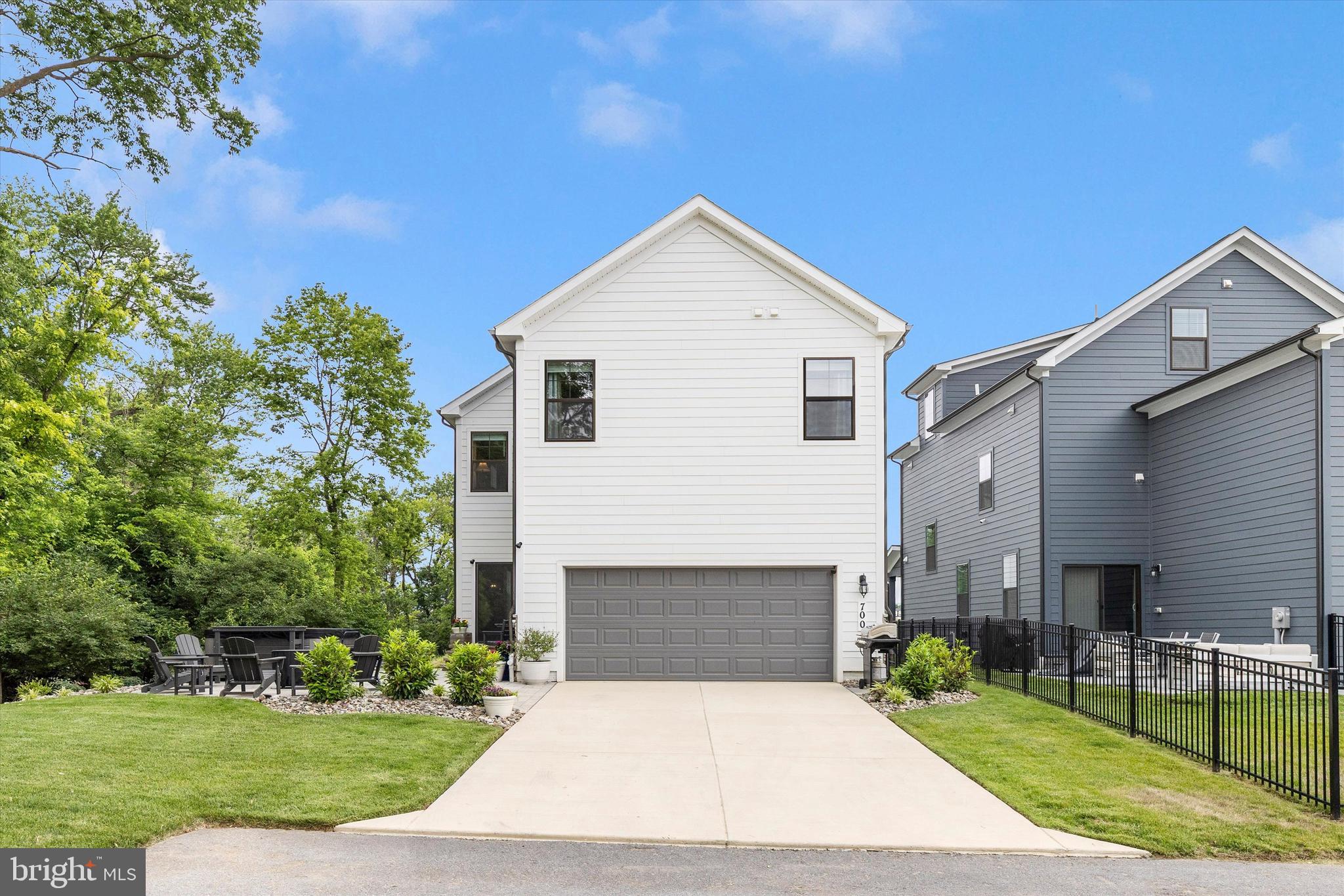 700 Bond Street Frederick, MD 21701 - Photo 42 of 49 a front view of a house with a yard and garage