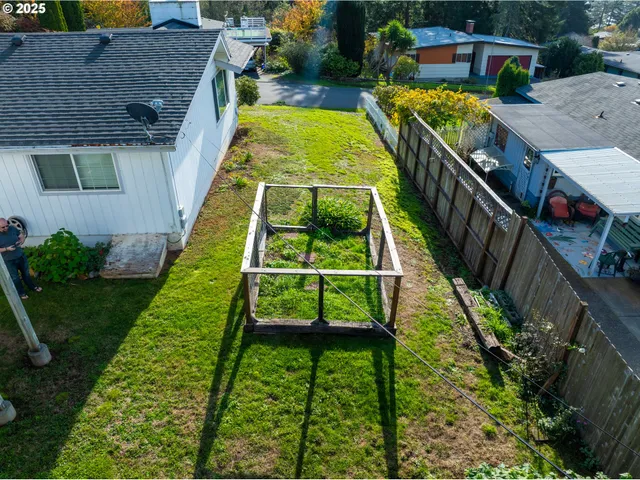 a view of house with backyard and sitting area