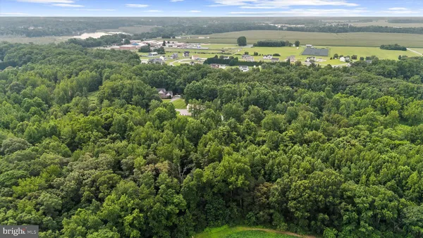 an aerial view of a houses with a yard