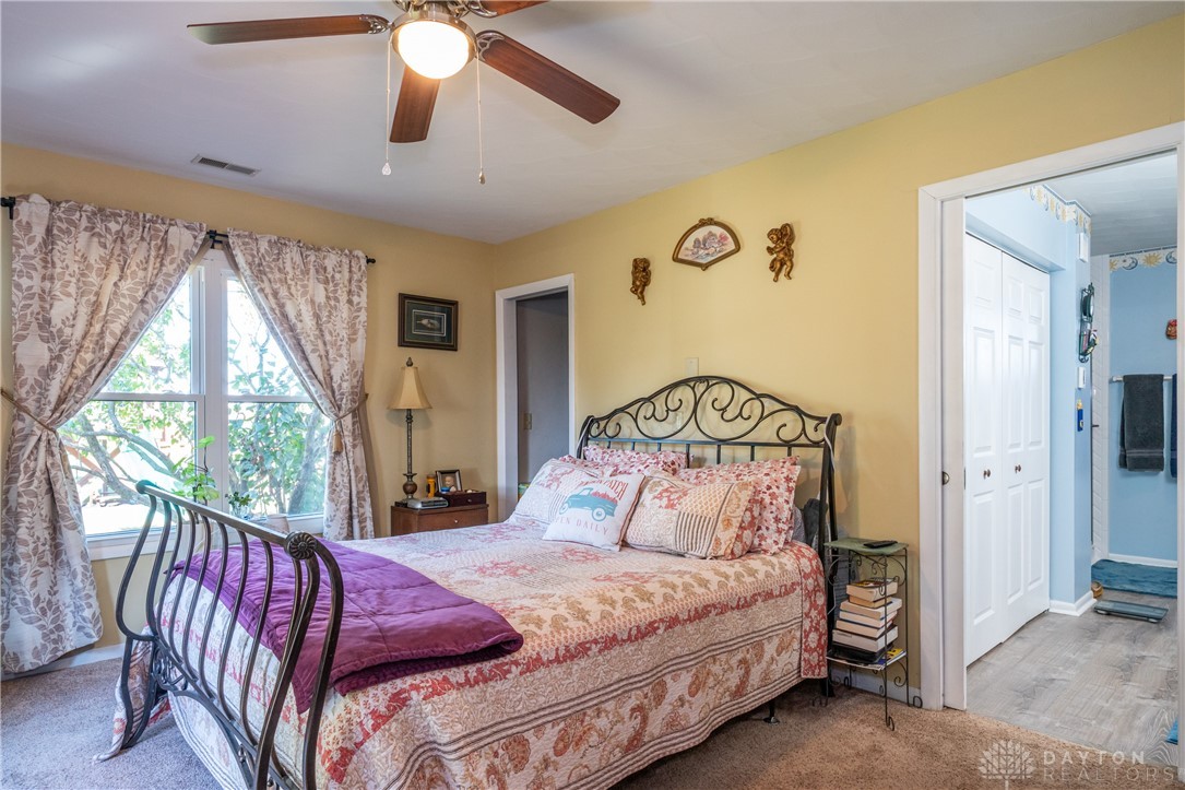 1599 Garringer Road Jamestown, OH 45335 - Photo 15 of 73 This restful bedroom features ample natural light and direct access to a private???????????????????????? bathroom.